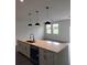 Modern kitchen island with quartz countertop and double sink at 1300 Hillsborough Ct, Kissimmee, FL 34759