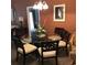 Bright dining room with glass-top table and six chairs at 113 Rogues Retreat, Davenport, FL 33897