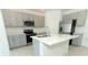 Modern kitchen with gray cabinets and quartz countertops at 353 River Front Way, Edgewater, FL 32141