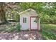 Small shed in the backyard with a red door at 2301 Ne 97Th Street Rd, Anthony, FL 32617