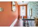 Upper hallway with stained glass window and coral walls at 2301 Ne 97Th Street Rd, Anthony, FL 32617