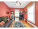 Cozy living room featuring hardwood floors, a leather couch, and a large TV at 2301 Ne 97Th Street Rd, Anthony, FL 32617
