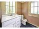 Simple bathroom with white vanity, toilet, and blue tile floor at 2301 Ne 97Th Street Rd, Anthony, FL 32617