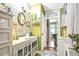 Charming bathroom with white vanity, green walls, and decorative mirror at 2301 Ne 97Th Street Rd, Anthony, FL 32617