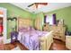 Bedroom with lavender bedding and light wood furniture at 2301 Ne 97Th Street Rd, Anthony, FL 32617