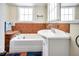 Bathroom with tiled walls, a bathtub, and a pedestal sink at 2301 Ne 97Th Street Rd, Anthony, FL 32617