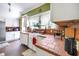 Galley kitchen featuring white cabinets, terracotta counters, and a farmhouse sink at 2301 Ne 97Th Street Rd, Anthony, FL 32617