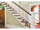 Classic wooden staircase with white railings and floral wallpaper at 2301 Ne 97Th Street Rd, Anthony, FL 32617