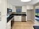 Modern kitchen with white cabinets and stainless steel appliances at 110 Lindenwood Ln, Kissimmee, FL 34743