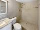 Updated bathroom with a walk-in shower, toilet and granite vanity at 110 Lindenwood Ln, Kissimmee, FL 34743