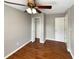 Spacious bedroom with wood-look floors and ceiling fan at 110 Lindenwood Ln, Kissimmee, FL 34743