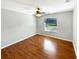 Bedroom with hardwood floors and a large window at 110 Lindenwood Ln, Kissimmee, FL 34743