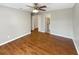 Spacious main bedroom with wood-look flooring and access to bathroom at 110 Lindenwood Ln, Kissimmee, FL 34743