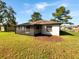 Back view of house showing screened porch and yard at 110 Lindenwood Ln, Kissimmee, FL 34743