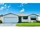 White single story home with a two car garage and landscaped lawn at 4901 Pleasant Hollow Trl, Lakeland, FL 33811