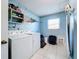 Laundry room with washer, dryer, and shelving at 10332 Olcot St, Orlando, FL 32817