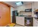 Well-equipped kitchen with black appliances and light cabinets at 2301 S Atlantic Ave # 327, Daytona Beach, FL 32118