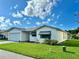 White single story home with a two car garage and landscaped lawn at 4901 Pleasant Hollow Trl, Lakeland, FL 33811