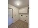 Laundry room with tile floor and white cabinets at 4901 Pleasant Hollow Trl, Lakeland, FL 33811
