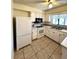 Efficient kitchen with white cabinets and tile floor at 4901 Pleasant Hollow Trl, Lakeland, FL 33811