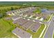 Aerial view of a new home community with houses, roads, and a lake at 957 King Parc Rd, Orange City, FL 32763