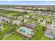 Aerial view of community pool, clubhouse, and surrounding neighborhood at 957 King Parc Rd, Orange City, FL 32763