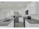 Modern kitchen featuring white cabinets, granite countertops, and stainless steel appliances at 957 King Parc Rd, Orange City, FL 32763