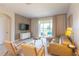 Living area features a gray sectional sofa, balcony access, and modern decor at 875 Ocean Course Ave, Davenport, FL 33896