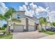 Modern three-unit townhome with attached garages at 875 Ocean Course Ave, Davenport, FL 33896
