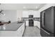 Modern kitchen with gray countertops, stainless steel appliances, and white cabinets at 875 Ocean Course Ave, Davenport, FL 33896