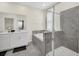 Modern bathroom with double sinks, a soaking tub, and a walk-in shower at 875 Ocean Course Ave, Davenport, FL 33896