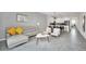 Open concept living and dining area with gray sectional sofa and adjacent kitchen at 875 Ocean Course Ave, Davenport, FL 33896