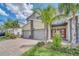 Modern two-story townhome with attached garage and red front door at 875 Ocean Course Ave, Davenport, FL 33896