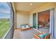 Screened lanai with outdoor furniture and golf course views at 875 Ocean Course Ave, Davenport, FL 33896