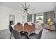 Open concept dining area with a modern table and chairs, and living room view at 875 Ocean Course Ave, Davenport, FL 33896