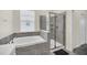 Modern bathroom with a soaking tub and walk-in shower at 875 Ocean Course Ave, Davenport, FL 33896
