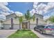 Three-unit townhome building with attached garages and palm trees at 875 Ocean Course Ave, Davenport, FL 33896
