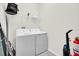 Laundry room with washer, dryer, and shelving for storage at 875 Ocean Course Ave, Davenport, FL 33896