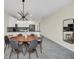Bright dining area with wood table and gray chairs, and open to kitchen at 875 Ocean Course Ave, Davenport, FL 33896