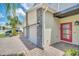 Modern townhome with attached garage and red front door, stone accents at 875 Ocean Course Ave, Davenport, FL 33896