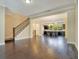 Open living room with dark hardwood floors and a view into the kitchen at 2159 Bosque Aly, Orlando, FL 32814