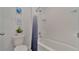 Clean bathroom with a shower/tub combo and white tile at 1708 Frogmore Ave, Haines City, FL 33844