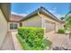 Exterior showing a side view of a house with a three-car garage and lush landscaping at 26841 Bella Vista Dr, Howey In The Hills, FL 34737
