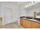 Clean bathroom with dual sinks, granite countertops, and a large mirror at 26841 Bella Vista Dr, Howey In The Hills, FL 34737