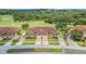 Tan two-story home with double garage and manicured lawn near golf course at 26841 Bella Vista Dr, Howey In The Hills, FL 34737