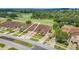 Aerial view showcasing a house with a two-car garage, nestled in a community with a golf course at 26841 Bella Vista Dr, Howey In The Hills, FL 34737