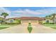 Tan two-story home with double garage and manicured lawn at 26841 Bella Vista Dr, Howey In The Hills, FL 34737