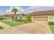 House exterior showcasing a three-car garage and well-manicured lawn at 26841 Bella Vista Dr, Howey In The Hills, FL 34737