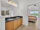 Bathroom boasts dual sinks, granite countertops and a view into bedroom at 26841 Bella Vista Dr, Howey In The Hills, FL 34737