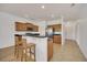 Kitchen with breakfast bar, stainless steel appliances, and wood cabinets at 26841 Bella Vista Dr, Howey In The Hills, FL 34737